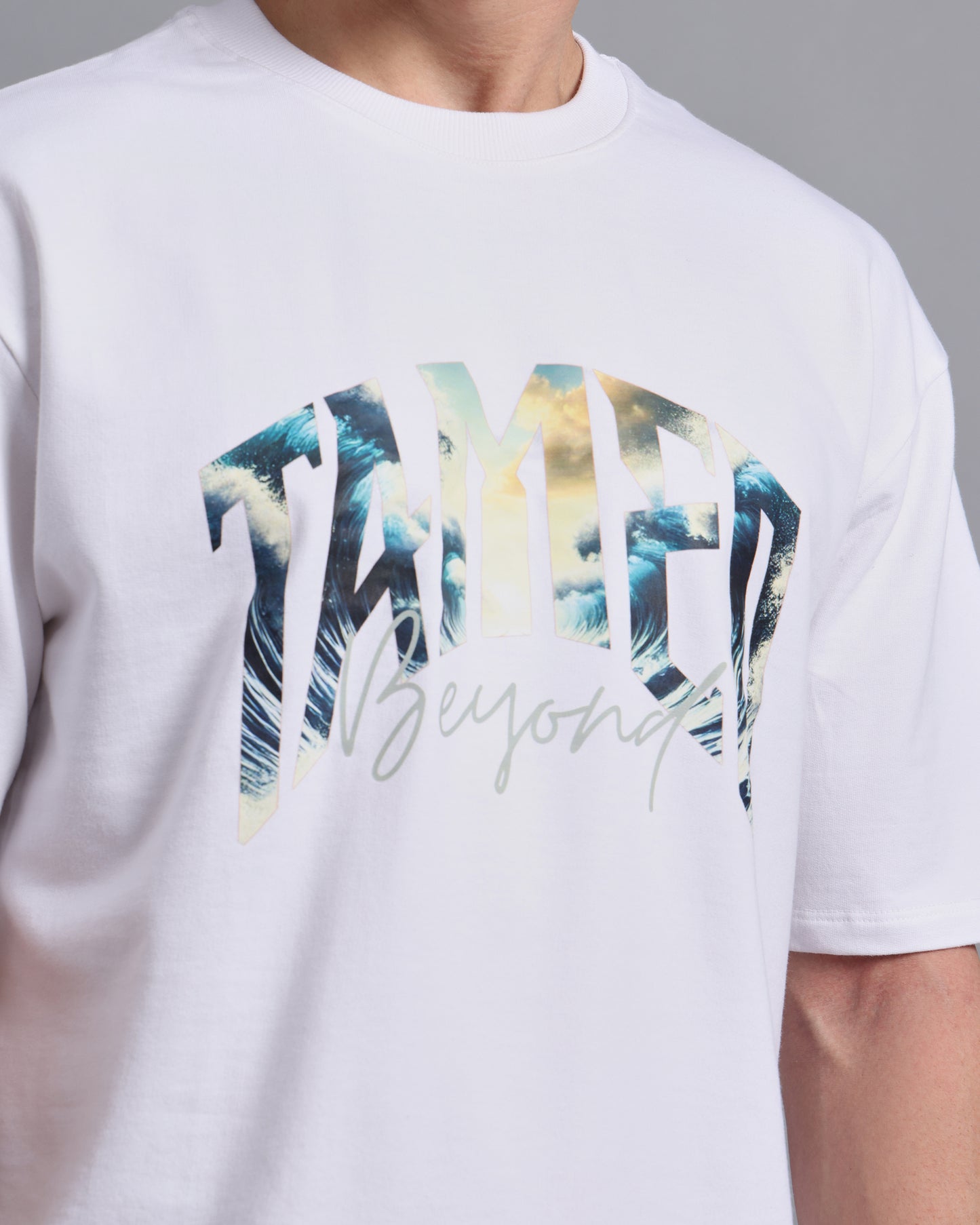 "TAMED BEYOND?"- white oversized tee