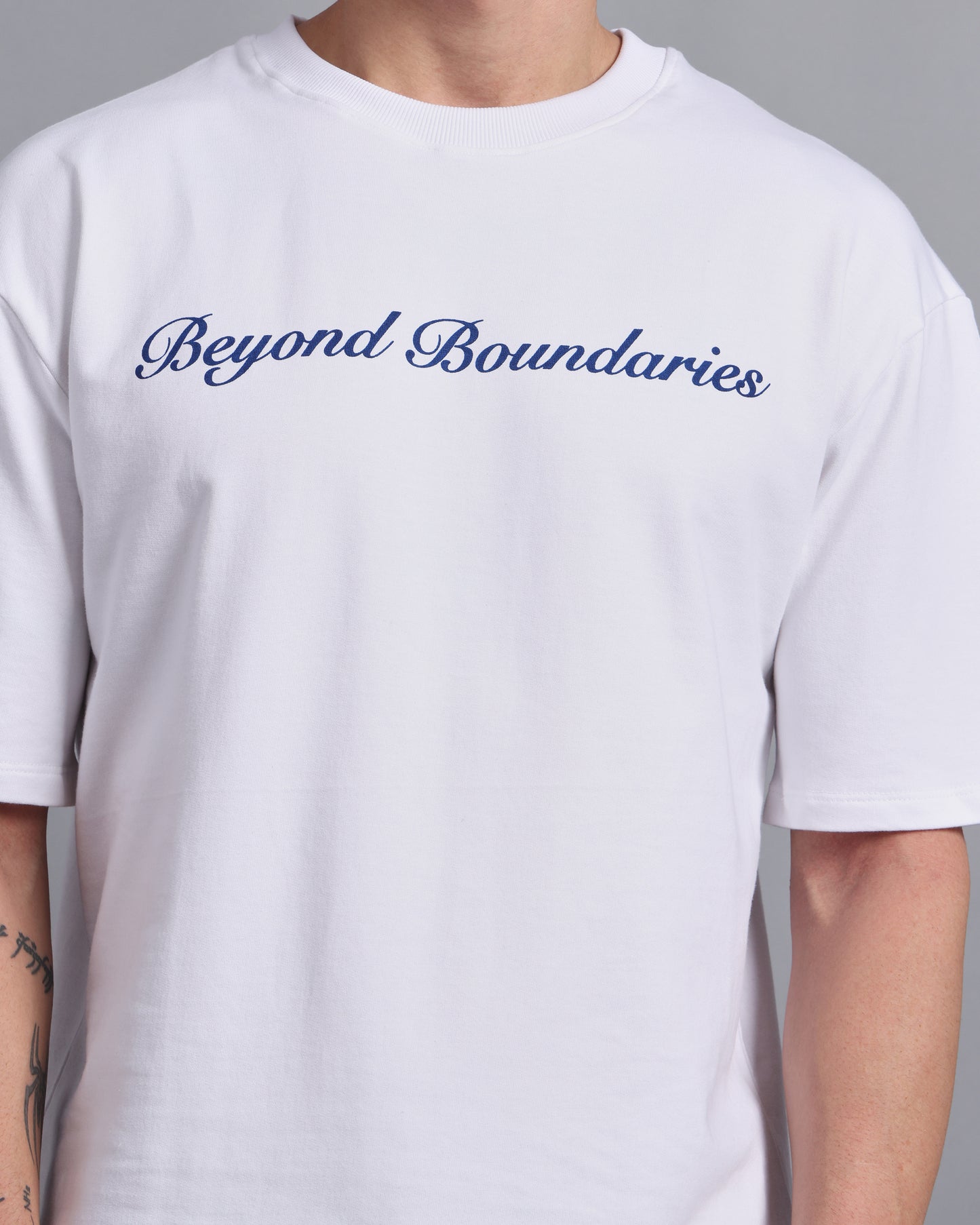 "BEYOND BOUNDARIES"- white oversized tee